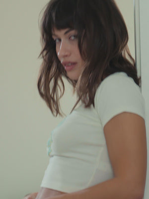 A woman wearing a black suspender belt with stockings.