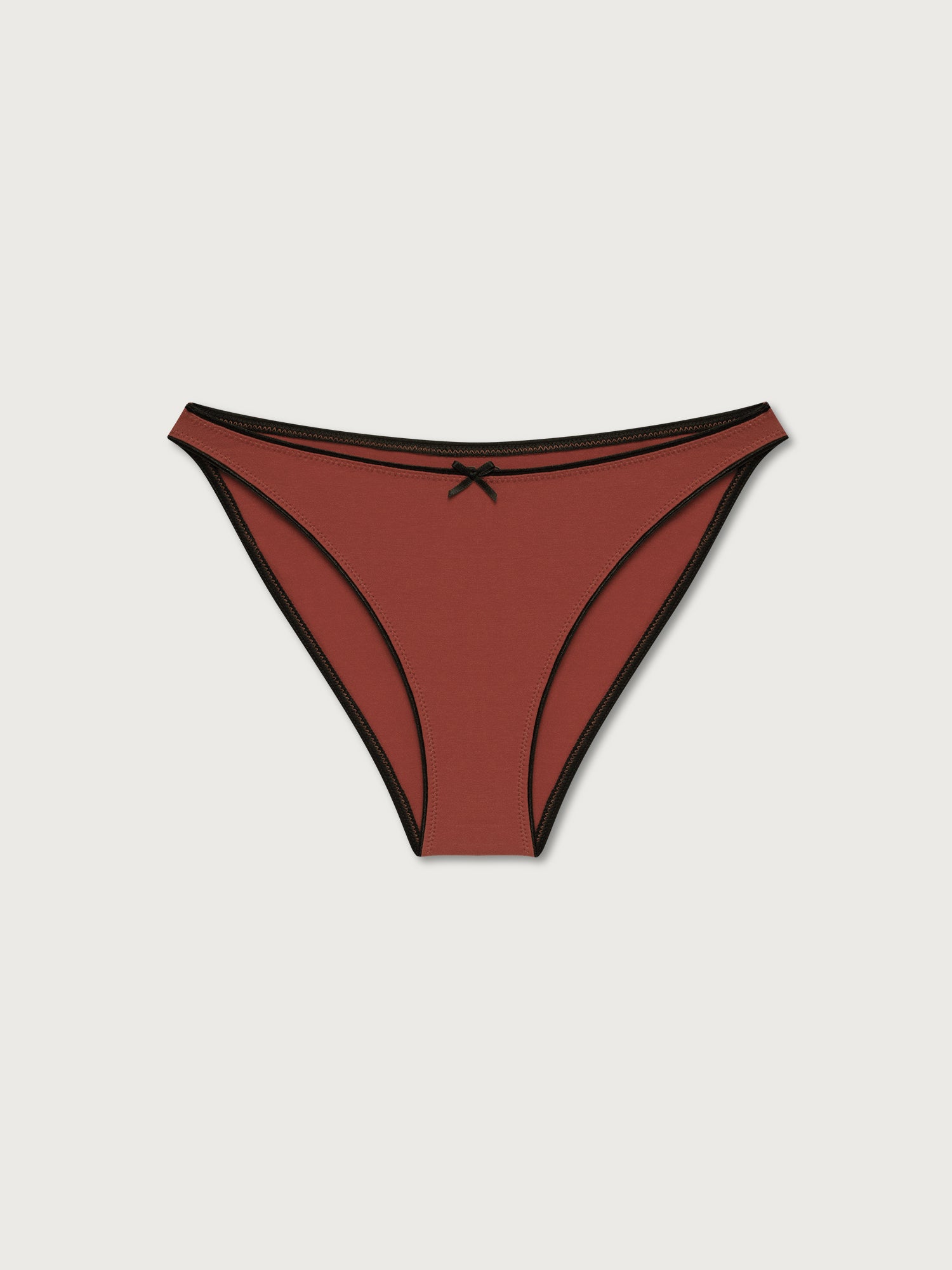 Terracotta bikini bottom with black trim on a light gray background